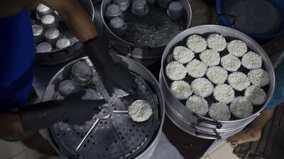 Rice is prepared for monks during daily alms-giving in Bangkok.