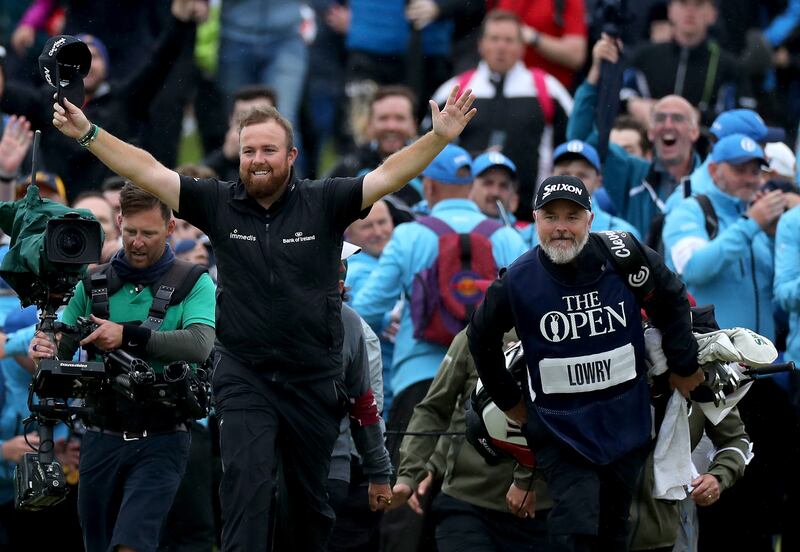 Shane Lowry of Ireland breaks through the huge crowds on the 18th hole and celebrates with his caddie Bo Martin at Royal Portrush. Photograph: David Cannon/Getty