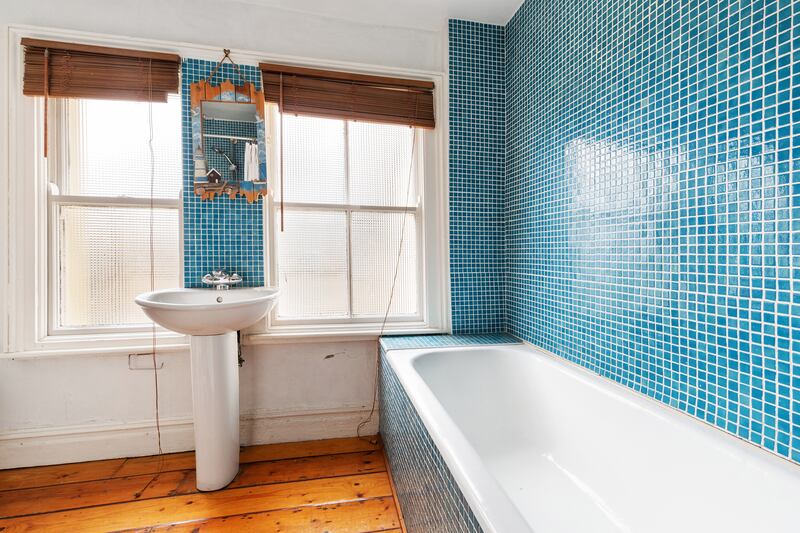 Family bathroom on first floor with mosaic blue tiles.