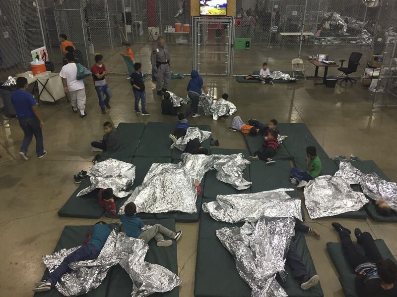 This US Customs and Border Protection photo obtained June 18, 2018 shows intake of illegal border crossers by US Border Patrol agents at the Central Processing Center in McAllen, Texas on May 23, 2018. / AFP PHOTO / US Customs and Border Protection / Handout /Getty Images