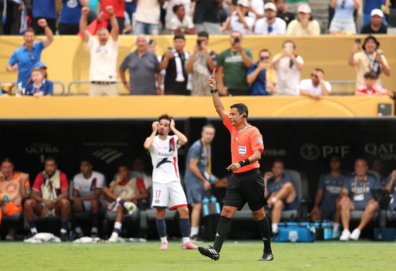 Referee Alireza Faghani issues a red card to Joao Neves of Paris Saint-Germain. Photograph: Luke Hales/Getty
