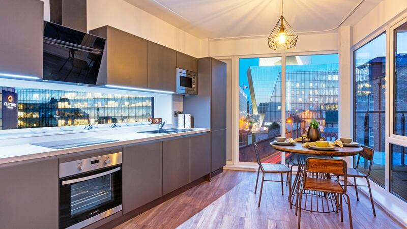 Eco Interiors designed the kitchens, which include taconite charcoal-coloured sinks, laminate countertops and strip LED lighting