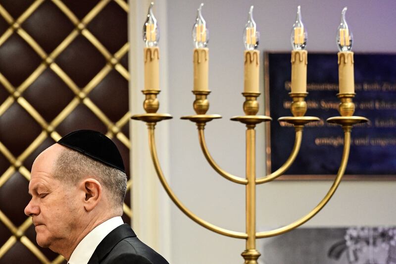 German chancellor Olaf Scholz walks past a candle holder towards a podium to speak during a ceremony to commemorate the 85th anniversary of Kristallnacht, in the Beth Zion Synagogue in Berlin in November. Photograph: John Macdougall/AFP via Getty Images