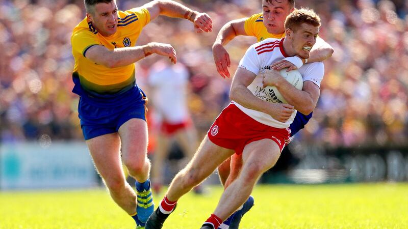 Tyrone’s Kyle Coney is tackled by Cathal Cregg and Enda Smith of Roscommon during their All-Ireland SFC Super 8s clash at Dr Hyde Park. Photo: Oisin Keniry/Inpho