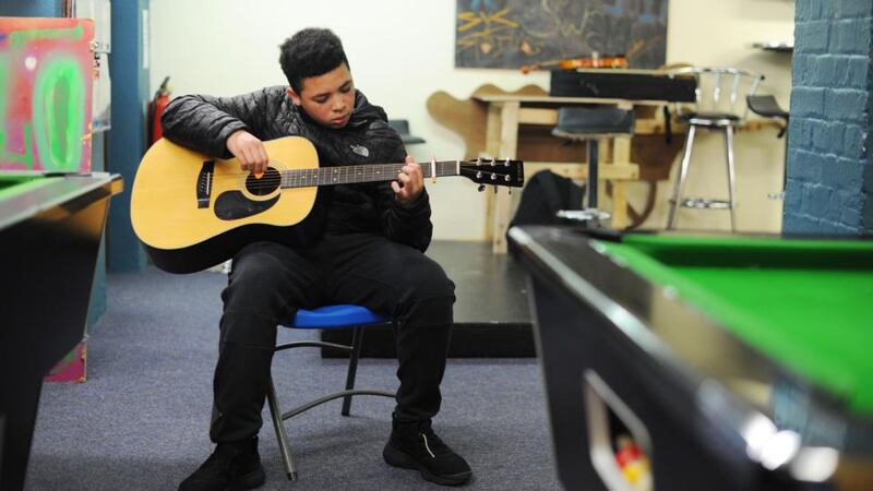 Justin Anene (13) plays guitar in the Swan youth services music group in the Swan Centre in Ballybough, Dublin. Photograph: Aidan Crawley