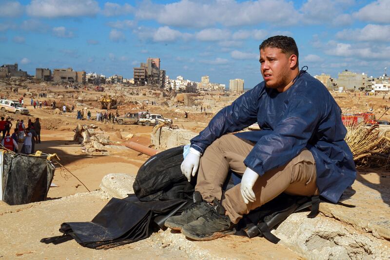 A volunteer sits on the rubble of a building in a flash flood-damaged area in Derna on Thursday. Photograph: Abdullah Doma/AFP via Getty Images