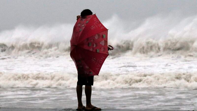 A Filipino resident watches strong waves at a coastal village in Borongan city, Samar island today. Photograph: EPA/FRANCIS R. MALASIG