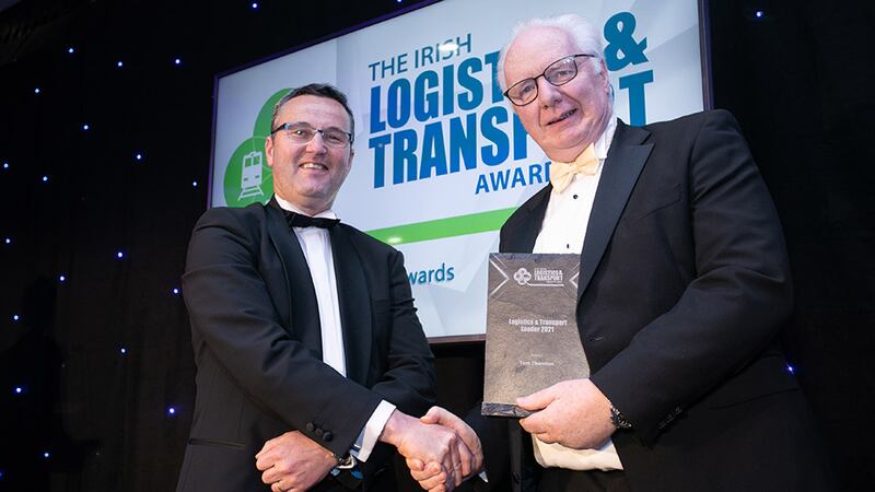 Sam Waide, Chief Executive Officer at the Road Safety Authority, presents the Logistics & Transport Leader 2021 award to Tom Thornton.