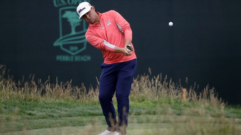 Woodland chips off the 17th green. Photo: Marcio Jose Sanchez/AP Photo