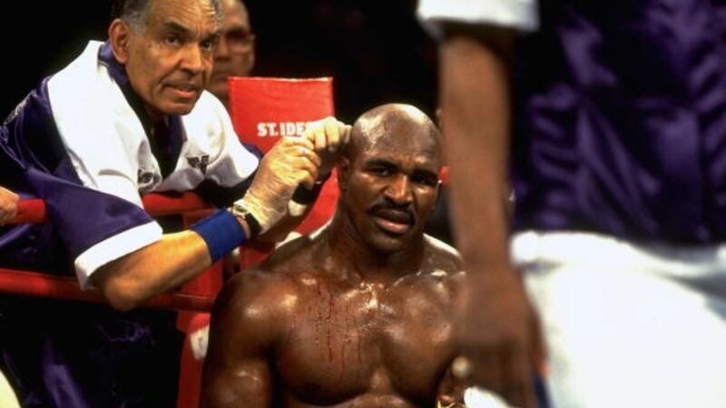 Evander Holyfield gets treatment in his corner after being bitten by Mike Tyson. Photograph: Manny Millan/Sports Illustrated/Getty