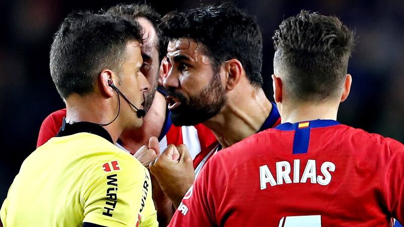 Atletico Madrid’s Diego Costa  argues with referee Jesus Gil Manzano  before receiving   a red card during the   La Liga  match against  Barcelona  at the Nou Camp. Photograph: Alberto Estevez/EPA