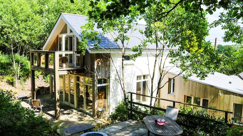 A sizeable T-shaped extension  was added to make the most of the gorgeous woodland site that includes a freshwater stream and small waterfall