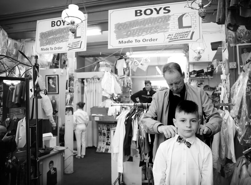 Ethan May (9) gets some help from his granddad Patrick May as tries out his new Communion suit at Jas Fagan's. Photograph: Bryan O’Brien