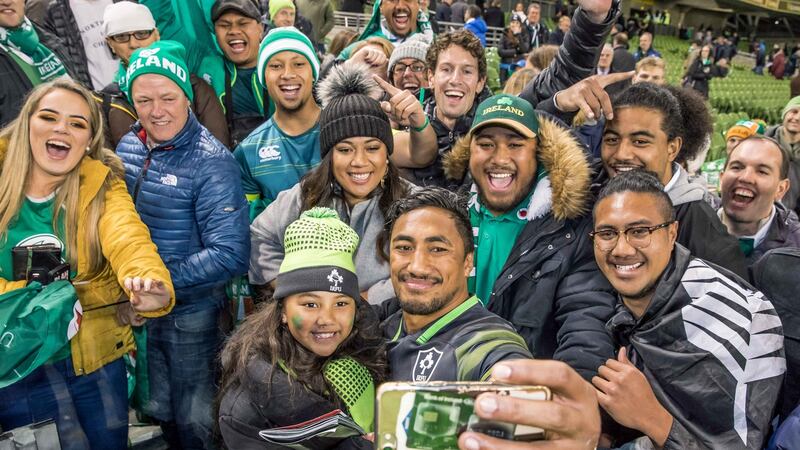 Bundee Aki takes a picture with his  daughter Adrianna Aki and family members. Photograph: Morgan Treacy/Inpho