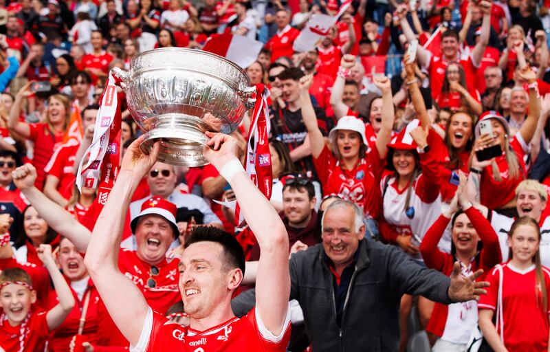 Louth's Tommy Durnin lifts the Delaney Cup in front of fans after the Leinster SFC final win against Meath. Photograph: Tom Maher/Inpho