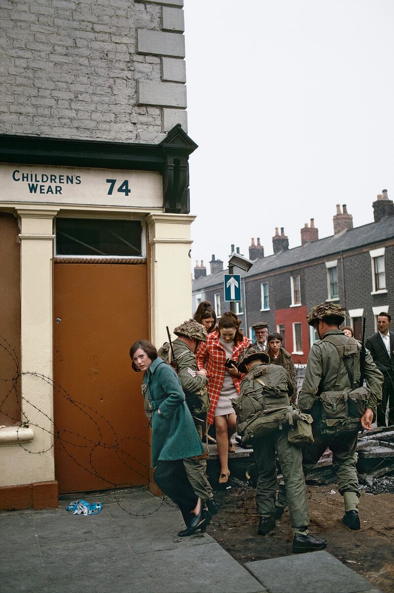 Women pass through a British army barricade about 1969.