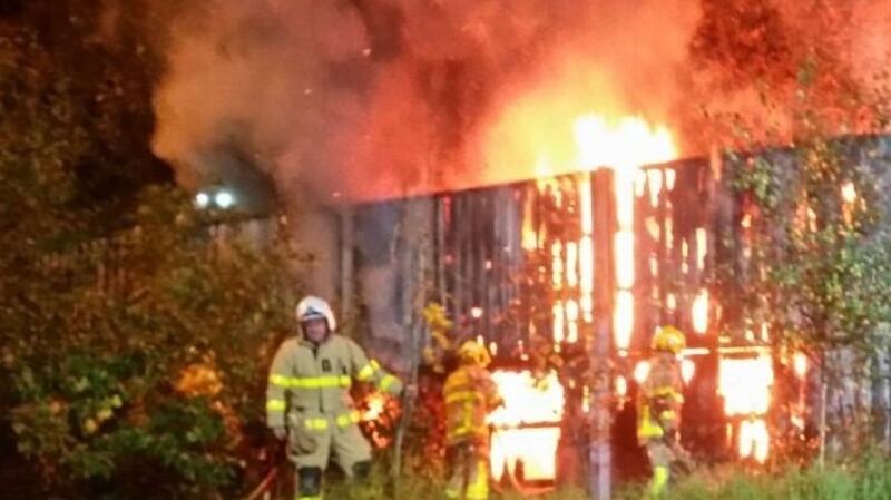 Dublin Fire Brigade  officers tackle a bonfire beside the M50 last night  that forced to the closure of two lanes of the motorway.