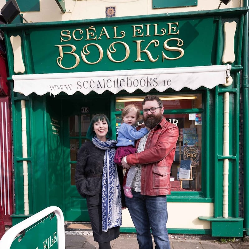 Pat Hynes and Eibhleann Ni Ghriofa outside their book shop with their daughter Eilbhe.