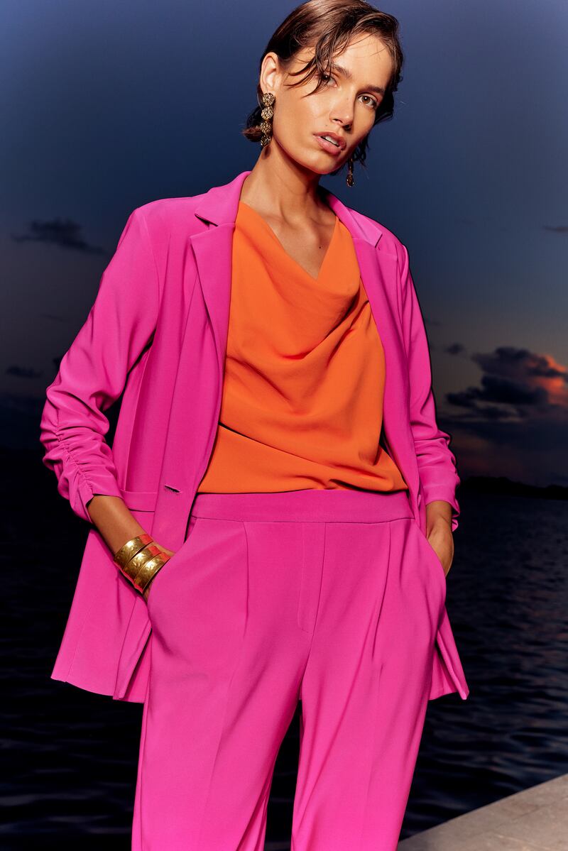 Pink trouser suit jacket with ruched sleeves, €299; trousers €239; mandarin cowl neck blouse, €180; all Joseph Ribkoff