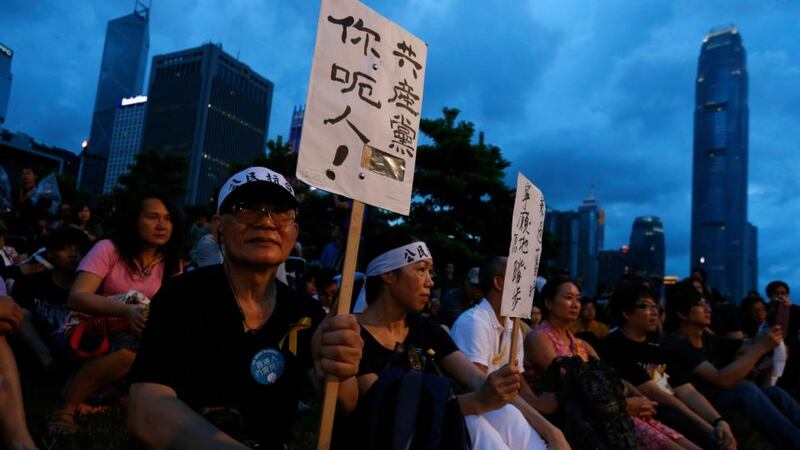 A pro-democracy protester carries a placard which reads “Communist Party, you lie!” as he sits with other protesters during a campaign to kick off the Occupy Central civil disobedience event in front of the financial Central district in Hong Kong . Photograph: Bobby Yip /Reuters