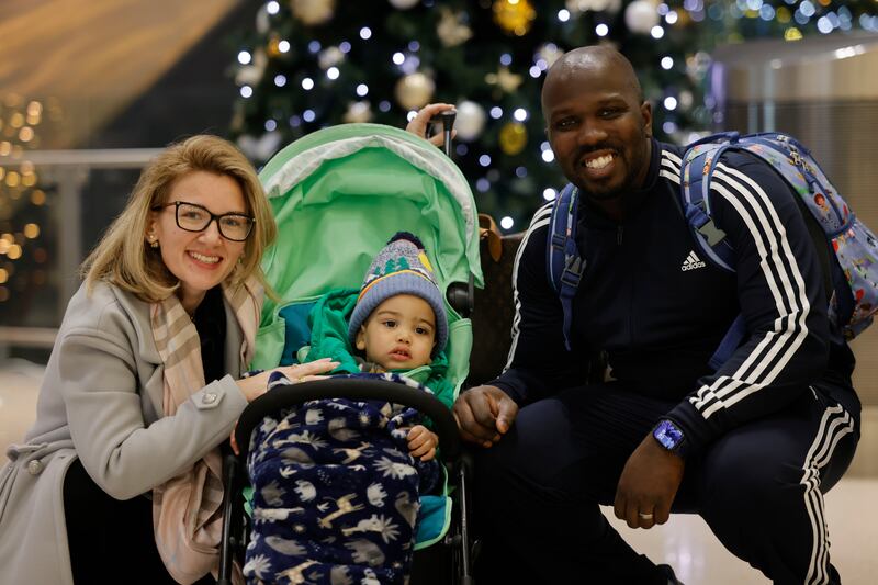 Sareen, Jaxon and Matt Williams  after arriving from New York on their way home to New Ross for Christmas  at Dublin Airport.  Photograph: Alan Betson / The Irish Times

