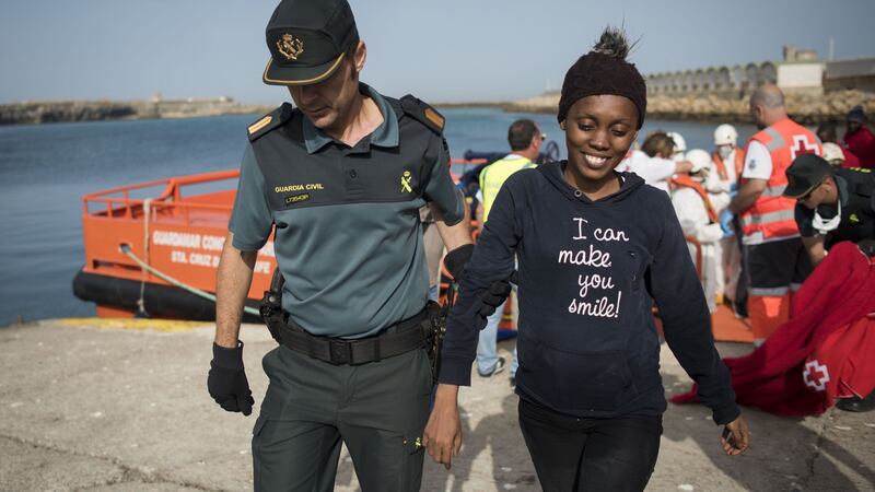 A Spanish Civil guard accompanies the only woman  amongst 143 Moroccans and 9 sub-Saharans rescued in  the Strait of Gibraltar in  June. Photograph: Marcos Moreno/AFP/Getty Images