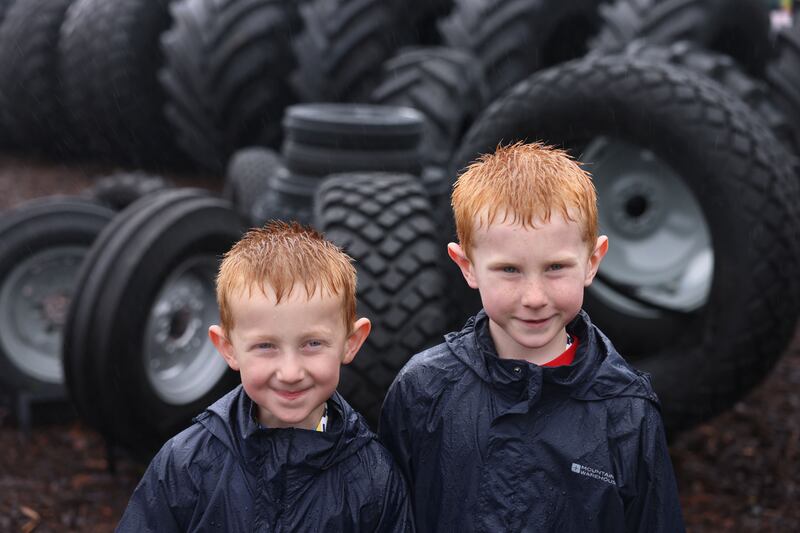 Brothers Cameron (4) and AJ Boland (6) from Gorey, Co Wexford make the most of the bad weather. Photograph: Dara Mac Dónaill/The Irish Times