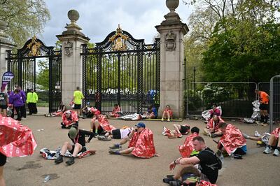 Runners recover after completing the 2024 London Marathon. Photograph: Justin Tallis/AFP via Getty Images