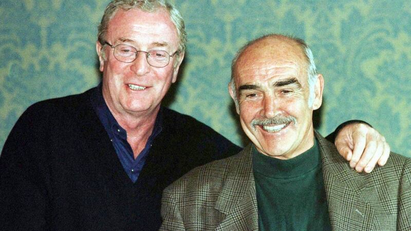 EDN03:BRITAIN-FESTIVAL:EDINBURGH,SCOTLAND,24AUG97 - British actors Sean Connery (R) and Michael Caine (L) stand on the stairs in Edinburgh's Caledonian Hotel, after holding a press conference to discuss the Film Festival's closing film,