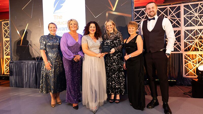 Denise McMorrow, awards judge, presents the best research project award to the ATU & UU team