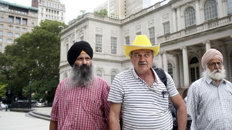 Three taxi drivers (from left) Lal Singh, Nicolae Hent and Lakhbir Rangar, after a city council meeting in New York last month. After six professional drivers died by suicide in the city, taxi drivers are talking more openly about depression. Photograph: Yana Paskova/The New York Times