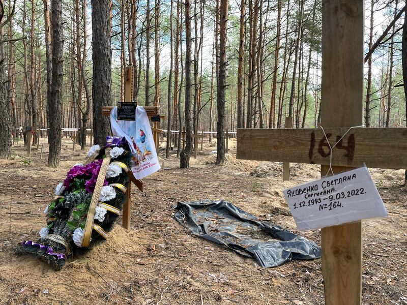 The grave of one person who has been identified in a mass burial pit in Izyum, eastern Ukraine. Photograph: Daniel McLaughlin