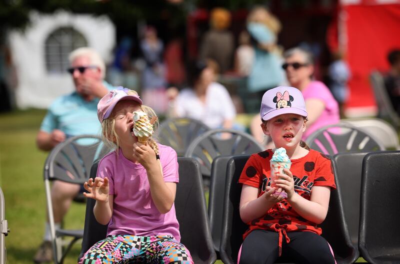 Heidi Brogan and Caitlin O’Brien from Carlow enjoy some ice cream in the Scarecrow Village. Photograph: Dara Mac Dónaill