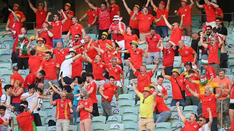 Travelling Wales fans celebrate Moore’s equaliser. Photo: Dan Mullan/Getty Images
