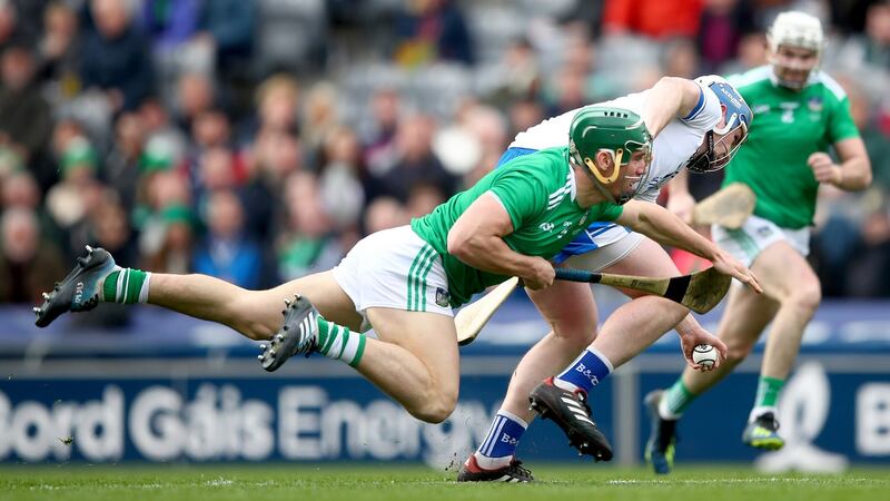 Limerick’s Sean Finn and Stephen Bennett of Waterford tussle for the ball. Photo: James Crombie/Inpho