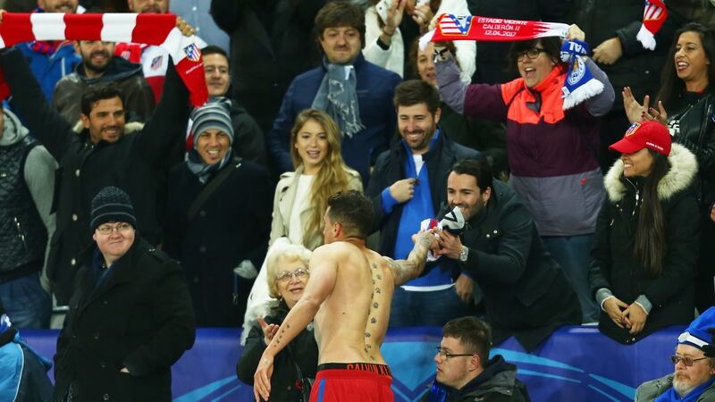Atlético’s Jose Maria Gimenez gives his jersey to a fan at the end of the game. Photo: Tim Keeton/EPA