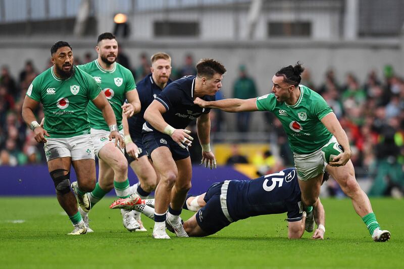 James Lowe of Ireland is tackled by Blair Kinghorn and Huw Jones of Scotland. Photograph: Charles McQuillan/Getty