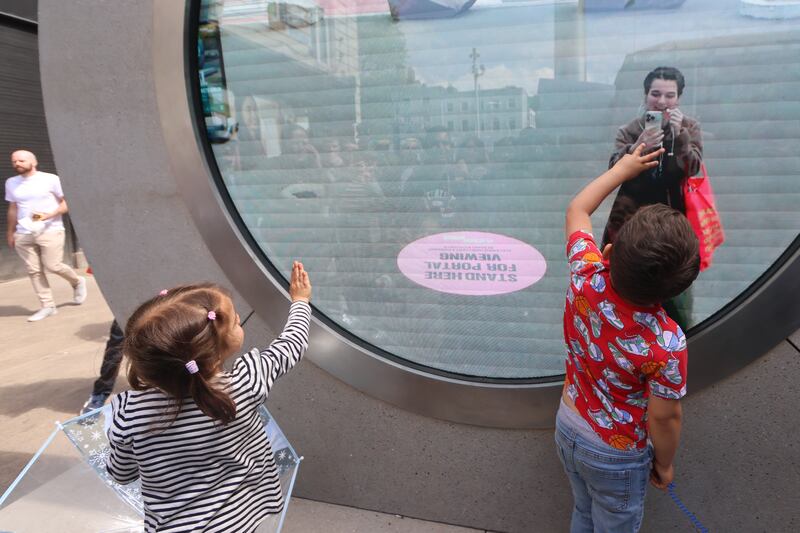 Two children say hello through a miracle of modern technology to a woman 6,000 kilometres away in New York City through a new portal erected at North Earl Street in Dublin.