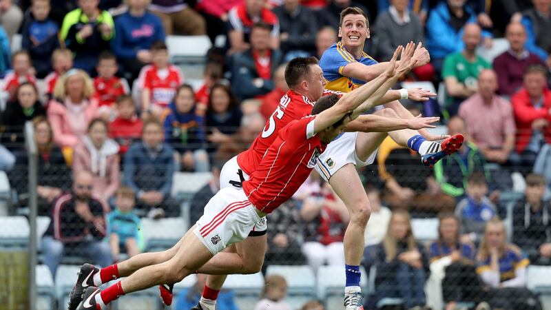 Tipperary’’s Conor Sweeney looks on after kicking a point despite the efforts of Paul Kerrigan and Jamie O’Sullivan. Photograph: Tommy Dickson/Inpho