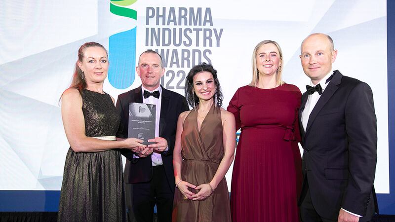 Susan Costello, Network Manager, BiopharmaChem Skillnet, presents the Graduate Training Programme of the Year award to the Bristol Myers Squibb Cruiserath team.