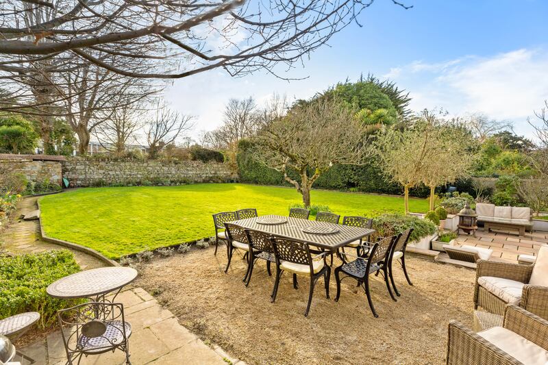 The private back garden is surrounded by granite walls, and several seating areas have been set up to catch the sun at various times of the day.