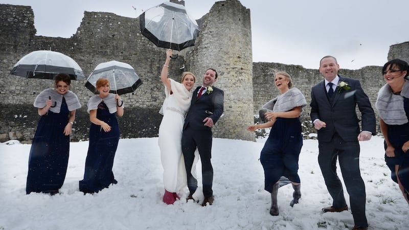 Claire Doggett and Gary Conroy brave the elements with bridesmaids and groomsmen  at Trim Castle. Photograph: Alan Betson