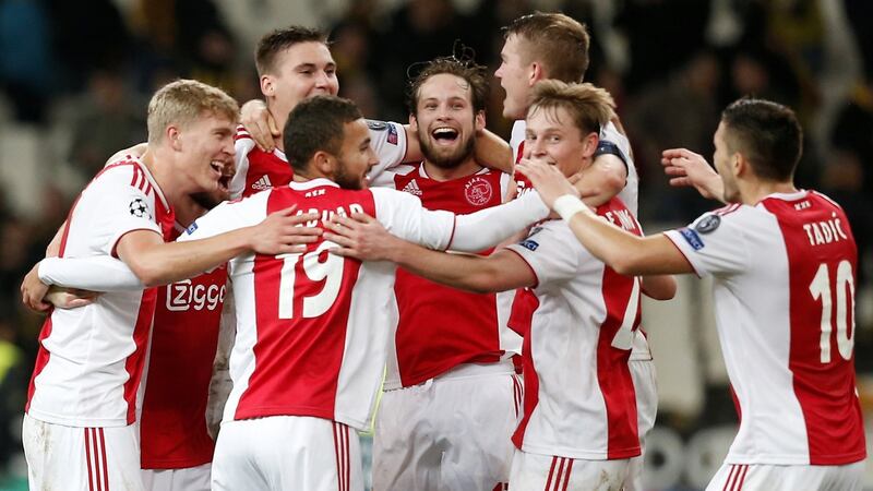 Ajax celebrate their progression into the last-16 of the Champions League. Photograph: Costas Baltas/Reuters
