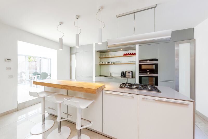 The Kitchen features sliding glass doors that open on to an overhanging glazed balcony.