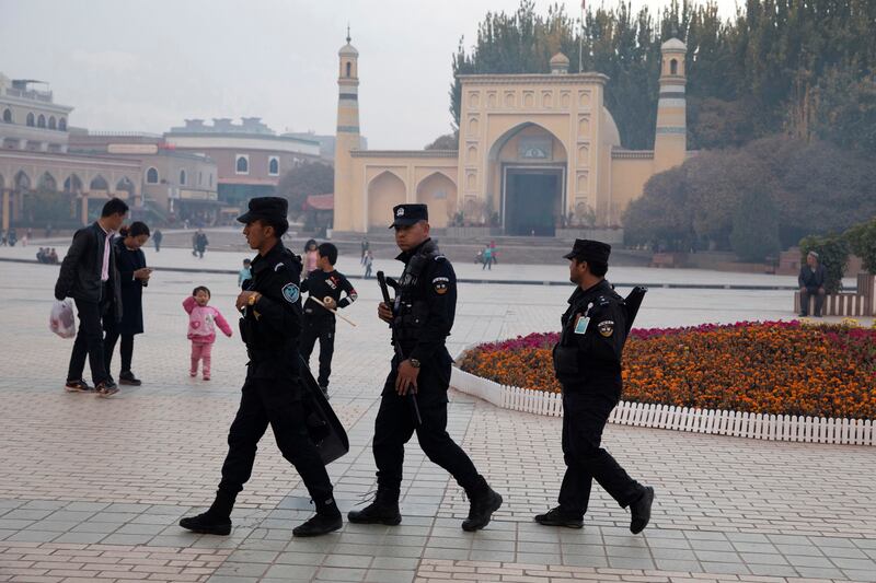 Security personnel patrol near the Id Kah Mosque in Kashgar in Xinjiang region where Uyghur people face restrictions on their religious freedoms. Photograph: Ng Han Guan/AP