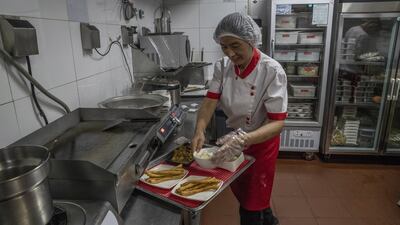 A chef at a Haidilao: the restaurant chin  has bucked China’s trend for poor customer service by going all out to greet, serve and entertain. Photograph; Gilles Sabrié/ The New York Times