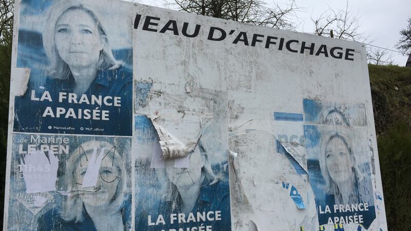 Faded Le Pen posters peel from a hoarding where Brachay’s two cafes once stood. Photograph: Lara Marlowe