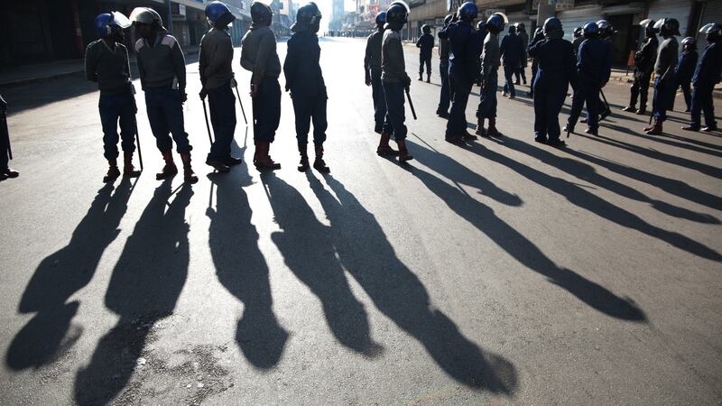 Members of the Zimbabwe Republic Police block the road to contain the planned Movement For Democratic Change  Alliance Peace March in Harare. Photograph: Aaron Ufumeli/EPA