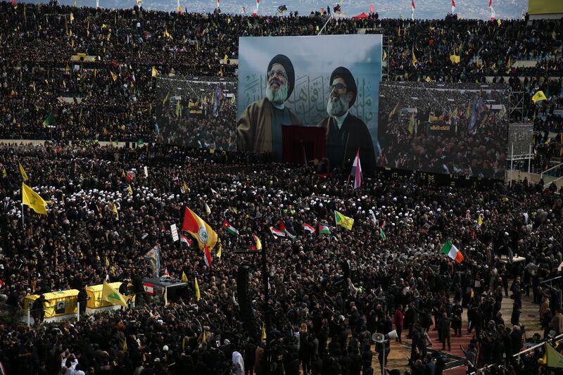 An Irish flag is visible as the coffins of Hassan Nasrallah and Hashem Safieddine approach the stage during Sunday's funeral. Photgraph: Sally Hayden