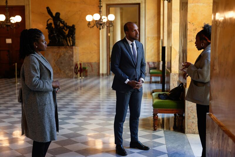 Olivier Serva, centre, proposed the bill to ban discrimination based on someone’s hair (AP Photo/Thibault Camus)